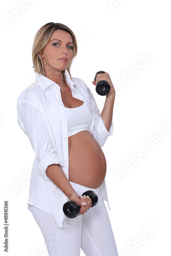 Photo: Pregnant woman using handweights Pregnant woman using handweights