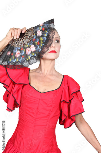 Photo: Woman flamenco dancer with red dress and open fan Woman flamenco dancer with red dress and open fan
