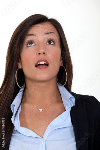 Photo: A surprised woman looking up at something A surprised woman looking up at something