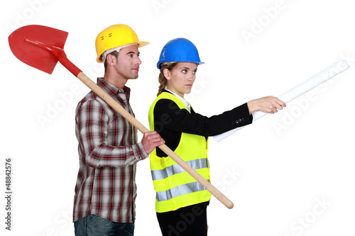 Photo: Building worker and woman supervising work on white background Building worker and woman supervising work on white background