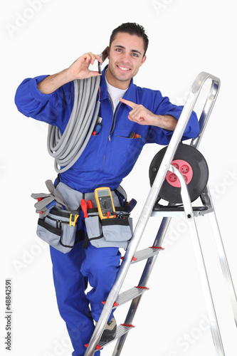 Photo: Electrician surrounded by equipment Electrician surrounded by equipment