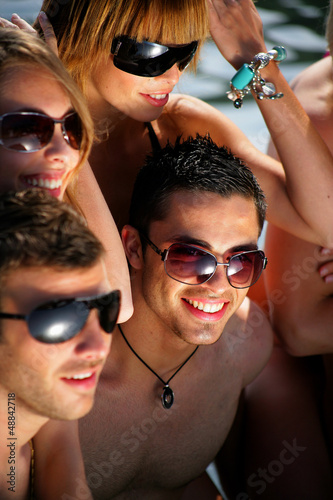 Photo: Group of young people on a beach holiday Group of young people on a beach holiday