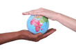 Photo: Two hands touching miniature globe Two hands touching miniature globe