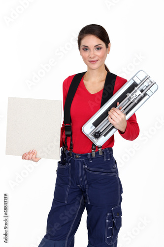 Photo: Craftswoman holding a tile Craftswoman holding a tile