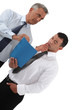 Two businessmen observing folder