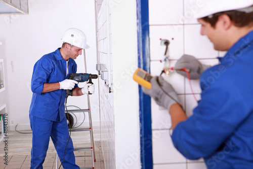 Photo: Trainee electricians learning their trade Trainee electricians learning their trade