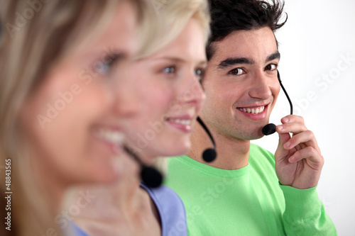 Photo: Young people working in a call centre Young people working in a call centre