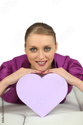 Photo: Cheerful girl with heart-shaped box Cheerful girl with heart-shaped box
