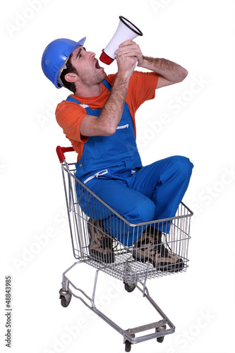 Photo: Tradesman sitting in a shopping cart Tradesman sitting in a shopping cart