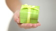 Colourful green gift in cupped hands