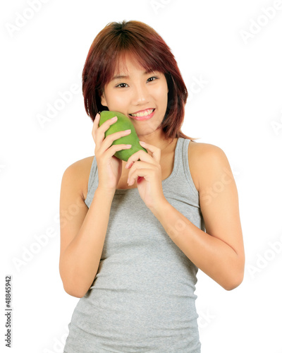 Photo: Isolated young asian woman with a mango over white. Isolated young asian woman with a mango over white.