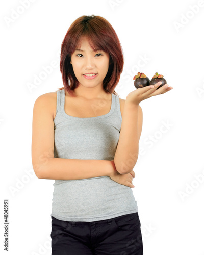 Photo: Isolated young asian woman with a mangoesteen over white. Isolated young asian woman with a mangoesteen over white.