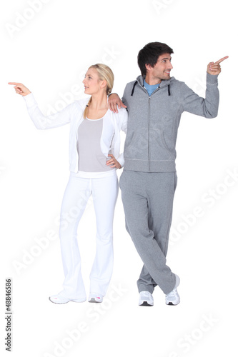 Photo: a blonde woman and a man in sports wear don't agree a blonde woman and a man in sports wear don't agree