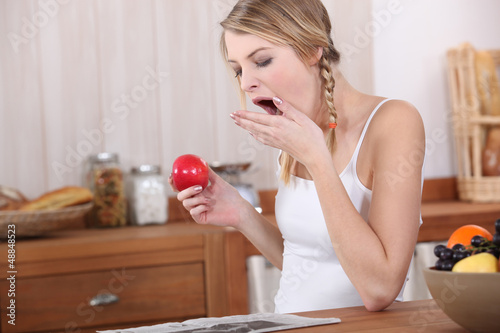 Photo: Woman yawning over breakfast Woman yawning over breakfast