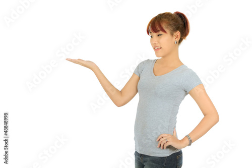 Photo: Isolated young asian woman presenting over white Isolated young asian woman presenting over white
