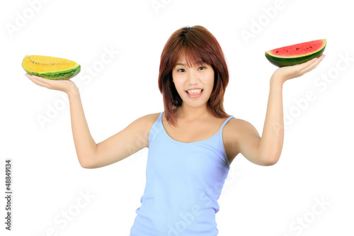 Photo: Isolated young asian woman with pieces of red and yellow waterme Isolated young asian woman with pieces of red and yellow waterme