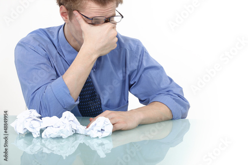 Photo: tired businessman rubbing his eyes tired businessman rubbing his eyes