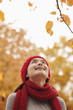 Chinese woman looking at autumn leaves