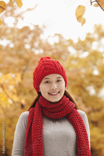 Photo: Smiling Chinese woman in autumn leaves Smiling Chinese woman in autumn leaves