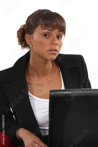 Photo: Portrait of woman sitting in front of laptop Portrait of woman sitting in front of laptop