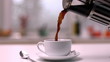 Coffee being poured from cafetiere into cup in kitchen