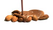 Melted chocolate being poured over almonds