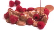 Chocolate pouring over raspberries in slow motion