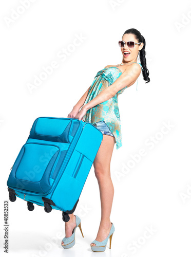 Photo: Woman holds the heavy travel suitcase Woman holds the heavy travel suitcase