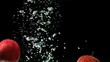 Apples falling into water in super slow motion