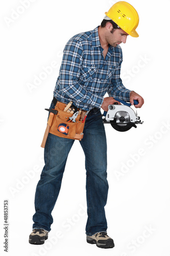 Photo: Construction worker with a disc cutter Construction worker with a disc cutter
