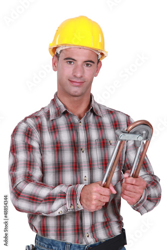 Photo: Tradesman using a tube bender Tradesman using a tube bender