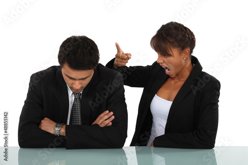 Photo: Woman reprimanding her employee Woman reprimanding her employee