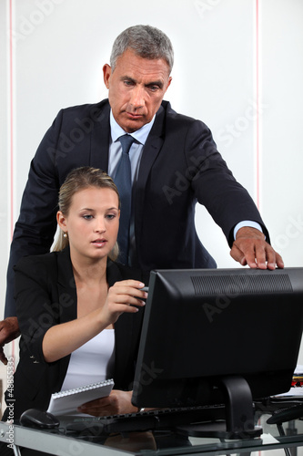 Photo: Personal assistant asking her boss a question Personal assistant asking her boss a question