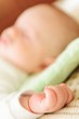 Cute newborn baby sleeping in bed