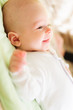 Cute newborn baby smiling in bed