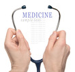 Hands holding a stethoscope isolated on white