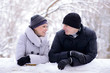 Portrait of a Young Smiling Couple Lying on the Snow