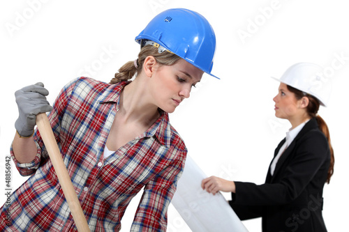 Photo: Labourer working beside an engineer Labourer working beside an engineer