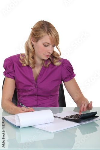 Photo: Woman calculating a budget Woman calculating a budget