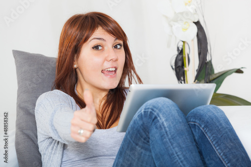 Photo: Beautiful Young Woman with Tablet PC on the Sofa Beautiful Young Woman with Tablet PC on the Sofa