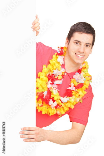 Photo: Smiling man wearing Hawaiian lei and posing on a panel Smiling man wearing Hawaiian lei and posing on a panel