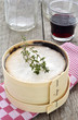 Photo: Mont d'Or cheese with red wine and thyme on red checked cloth Mont d'Or cheese with red wine and thyme on red checked cloth