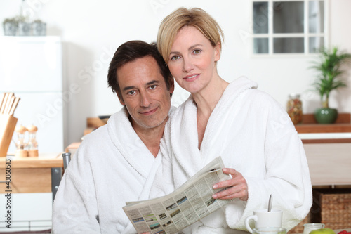 Photo: Couple reading the newspaper Couple reading the newspaper