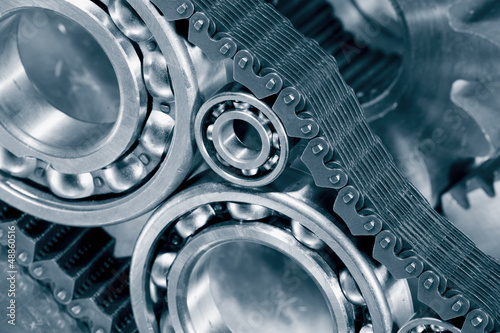 Photo: engineering parts, ball-bearings and chains in blue engineering parts, ball-bearings and chains in blue