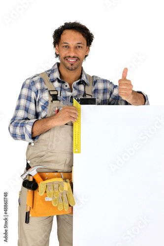 Photo: Builder stood with blank advertising panel Builder stood with blank advertising panel