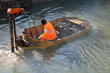 boat for River Cleanup and a worker