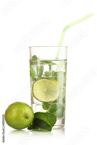 Photo: Glass of water with ice, mint and lime isolated on white Glass of water with ice, mint and lime isolated on white