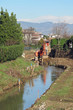 bulldozer at work on the bed of a river during consolidation of