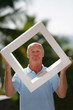 Bald man stood in his garden holding modern art