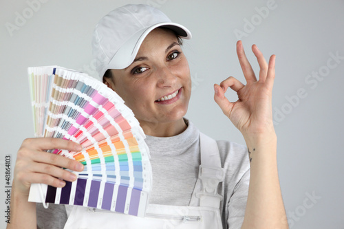 Photo: Painter giving the a-ok sign and holding a palette of colors Painter giving the a-ok sign and holding a palette of colors